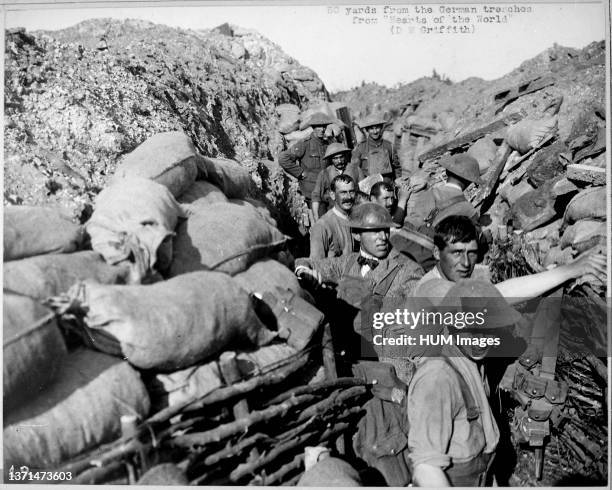 Repairing front line trench after bomb explosion fifty yards from enemy trenches. D. W. Griffith in civilian clothing. During filming of the motion...