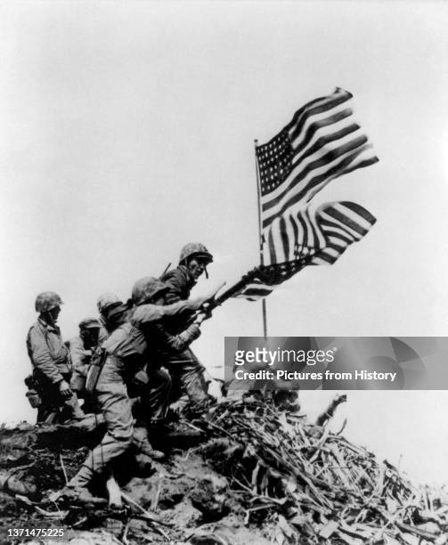 Raising the Stars and Stripes on Iwo Jima, 23 February, 1945.