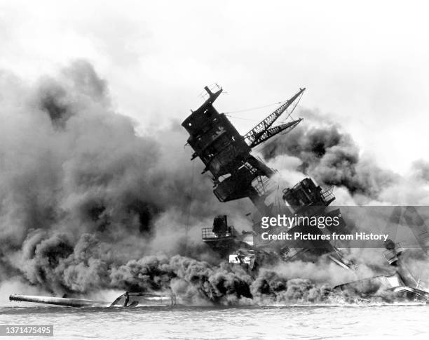 The USS Arizona burning after the Japanese attack on Pearl Harbor, 7 December 1941.