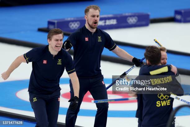 Christoffer Sundgren, Rasmus Wranaa, Oskar Eriksson and Niklas Edin of Team Sweden celebrate winning gold against Team Great Britain during the Men's...