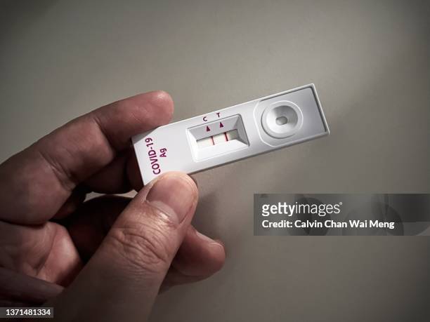 positive test result shown on a coronavirus covid-19 or sars cov-2 test on home test kit - covid 19 stock pictures, royalty-free photos & images