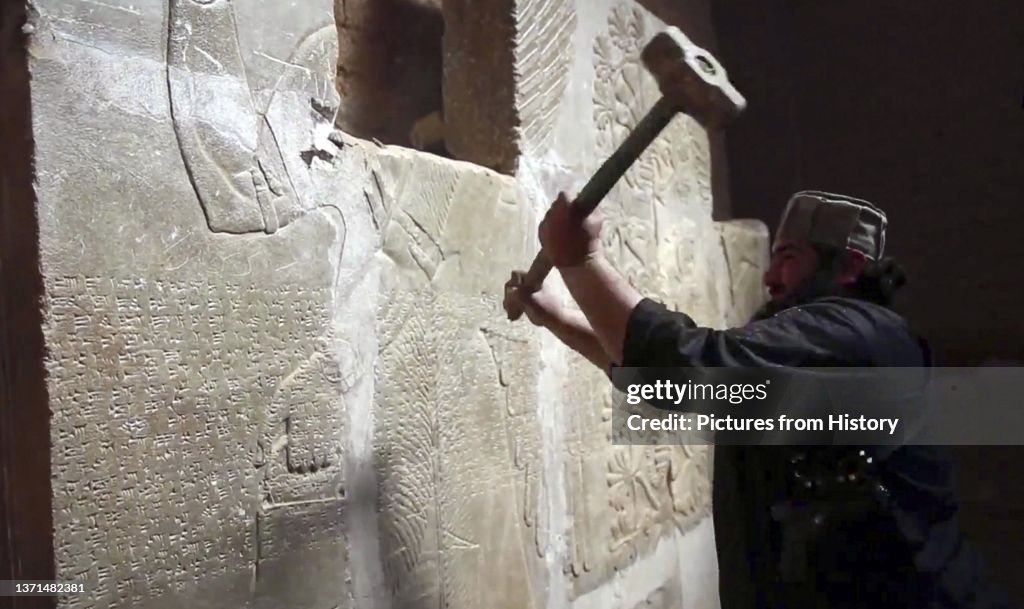 Islamic State/Iraq: An ISIL militant uses a sledgehammer to destroy a bas relief on a wall in Nimrud (1350 - 610 BCE) an ancient Assyrian city in Mosul, northern Iraq, March 2015