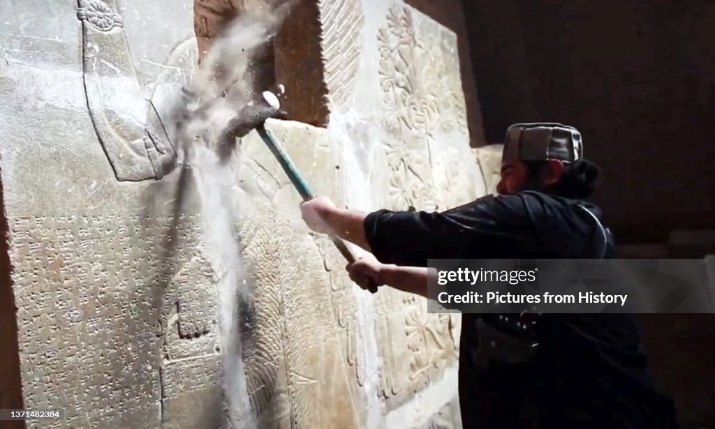 Islamic State/Iraq: An ISIL militant uses a sledgehammer to destroy a bas relief on a wall in Nimrud (1350 - 610 BCE) an ancient Assyrian city in Mosul, northern Iraq, March 2015