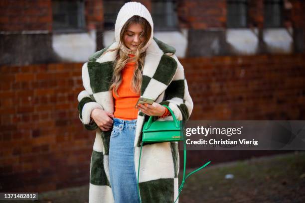 Guest is seen wearing green white checkered faux fur coat, balaklava, denim jeans, green Jacquemus bag outside Bora Aksu during London Fashion Week...