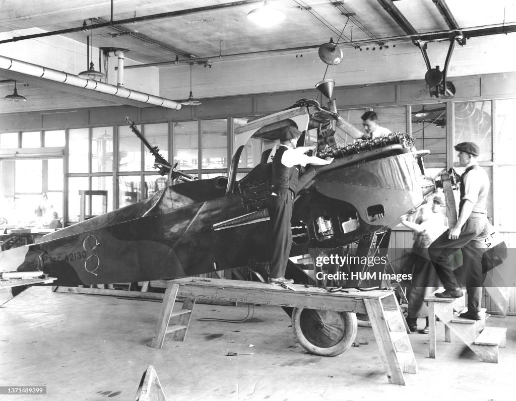 1918 - Manufacturing Le Pere Liberty Battle Planes for the Government at the Packard Motor Car Co., Plant, Detroit, Michigan. Setting engine in plane