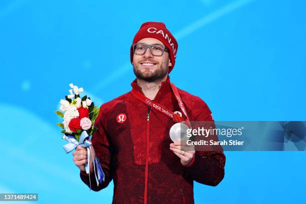 Silver Medallist Laurent Dubreuil of Team Canada poses with their medal during the Men's 1000m medal ceremony on Day 15 of the Beijing 2022 Winter...