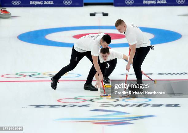 Hammy McMillan, Grant Hardie and Bobby Lammie of Team Great Britain compete against Team Sweden during the Men's Curling Gold Medal Game on Day 14 of...