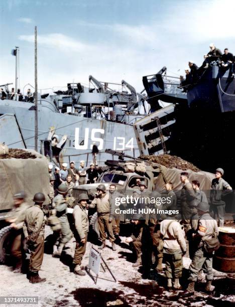 Trucks which will carry supplies to front line troops when the assault against Hitler's Europe begins, are being loaded on an LST in a British port.