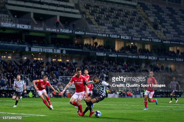 Julian Weigl of SL Benfica competes for the ball with Kenji Gorre of Boavista FC during the Liga Portugal Bwin match between Boavista FC and SL...
