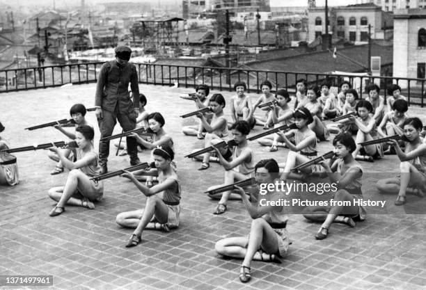 Japanese women rehearse a patriotic dance on a rooftop in Osaka during the Second Sino-Japanese War, July 1938.