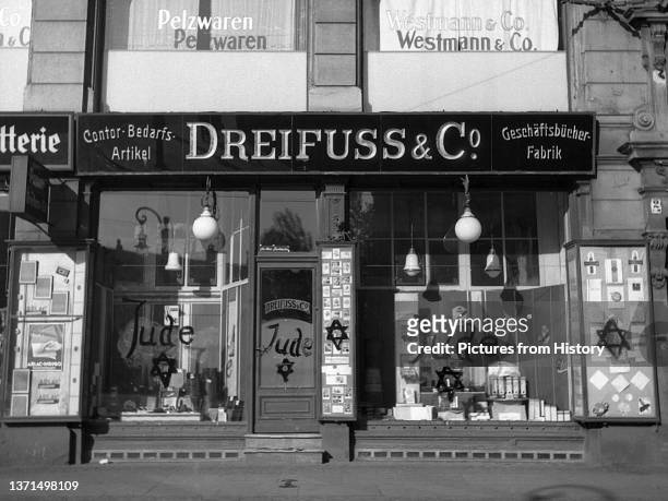 Jewish-owned shop after being vandalized by Nazis and covered with anti-Semitic graffiti, November 10, 1938.