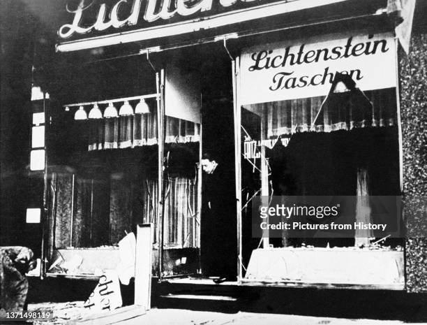 Man surveys the damage to the Lichtenstein leather goods store after the Kristallnacht pogrom, November 10, 1938.