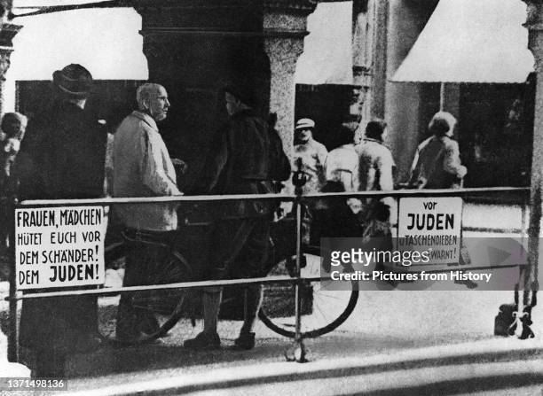 Anti-Jewish posters on a street in central Germany, late 1930s.