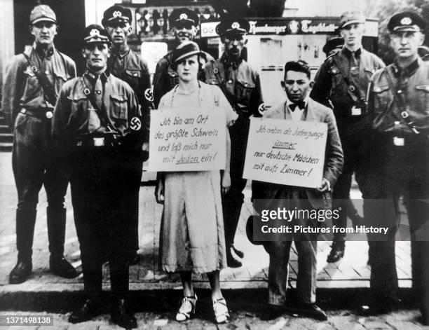 Jewish man and a non-Jewish woman pilloried by Nazis for 'rassenschande' , Cuxhaven, Germany, July 1933.