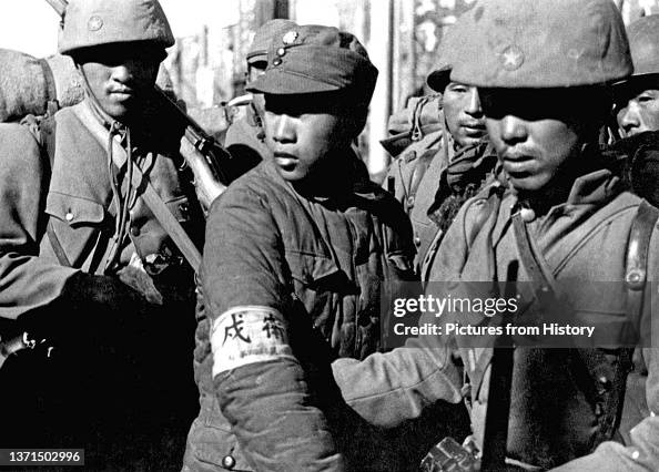 Imperial Japanese soldiers flank a Chinese soldier captured at the ...
