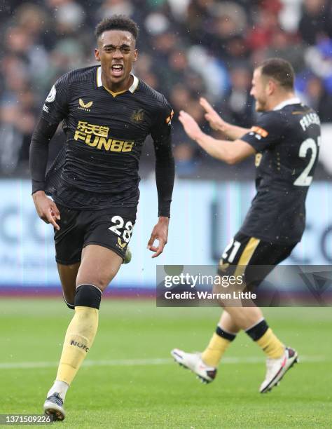 Joe Willock of Newcastle United celebrates after scoring their team's first goal during the Premier League match between West Ham United and...