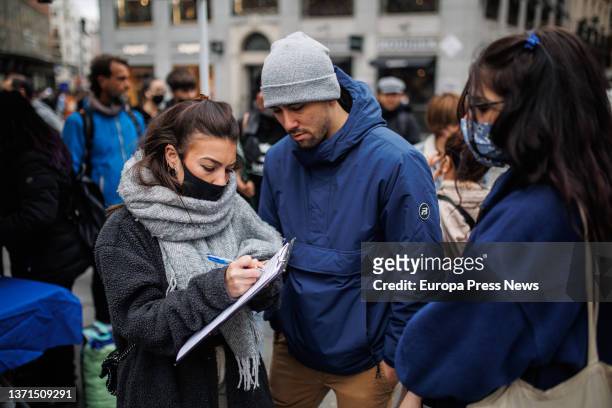 Group of people collect signatures at a rally to demand the regularization of all migrants in an irregular administrative situation, on 19 February,...