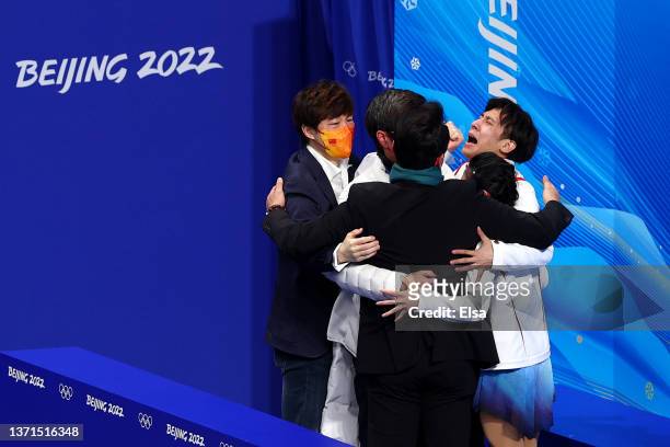 Wenjing Sui and Cong Han of Team China celebrate with team members after winning the Gold medal during the Pair Skating Free Skating on day fifteen...
