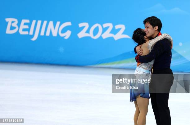 Gold medallists Wenjing Sui and Cong Han of Team China celebrate during the Pair Skating Free Skating Medal Ceremony on day fifteen of the Beijing...
