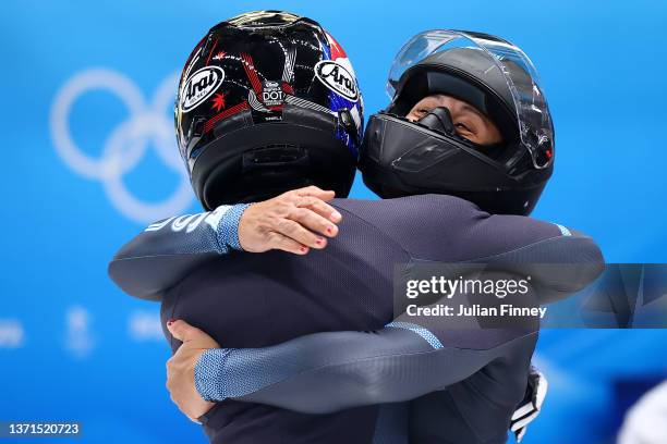 Bronze medal winners Elana Meyers Taylor and Sylvia Hoffman of Team United States celebrate following the 2-woman Bobsleigh Heat 4 on day 15 of...