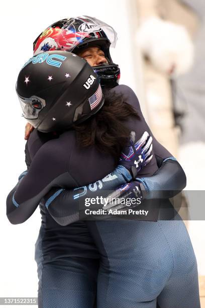 Bronze medal winners Elana Meyers Taylor and Sylvia Hoffman of Team United States celebrate following the 2-woman Bobsleigh Heat 4 on day 15 of...