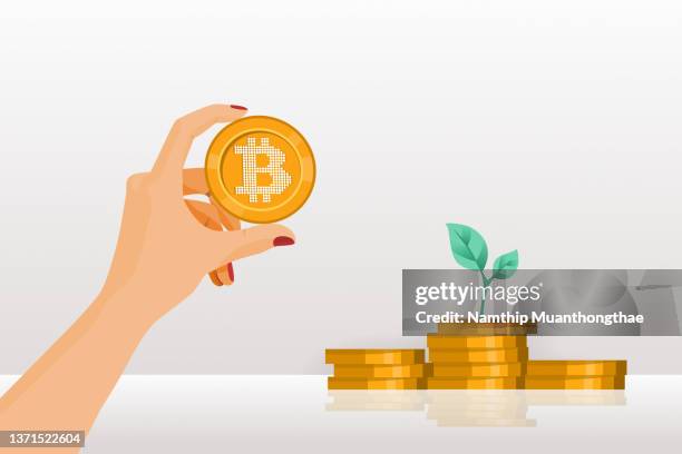 growing digital currency illustration concept shows a woman hand holding the bitcoin symbol with the piles of golden coins that showing the growth of cryptocurrency market. - small stock illustrations stock pictures, royalty-free photos & images