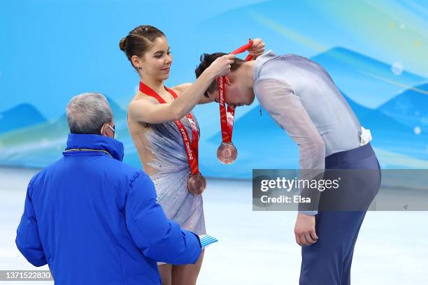 Bronze Medallists Anastasia Mishina and Aleksandr Galliamov of Team ROC put on their medals being presented them by Zaiqing Yu, IOC Vice-President...