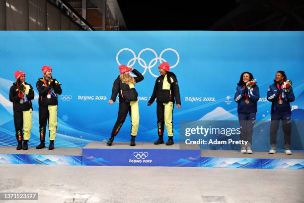 Gold medal winners Laura Nolte and Deborah Levi of Team Germany celebrate on the podium as Silver medal winners Mariama Jamanka and Alexandra...