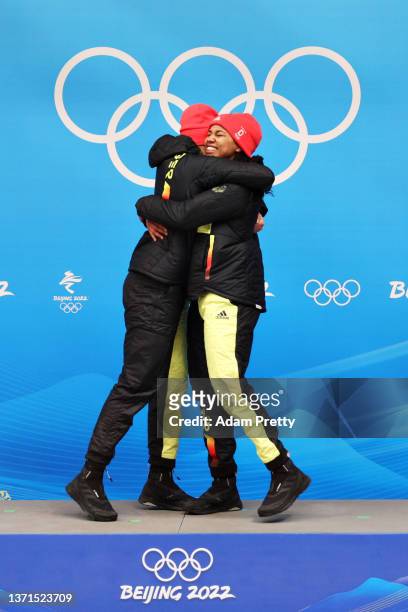 Gold medal winners Laura Nolte and Deborah Levi of Team Germany celebrate on the podium during the flower ceremony following the 2-woman Bobsleigh...