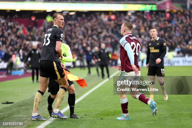 Dan Burn of Newcastle United clashes with Jarrod Bowen of West Ham United during the Premier League match between West Ham United and Newcastle...