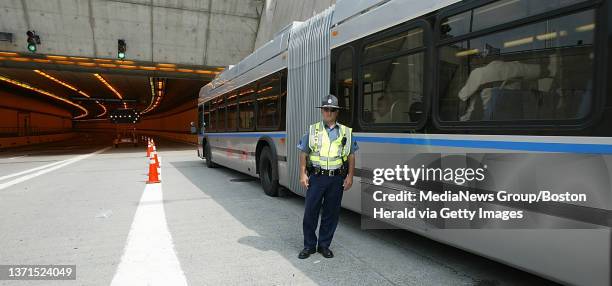 State Police Sergeant Mark Horgan watches busses filing through the Ted Williams Tunnel eastbound. .