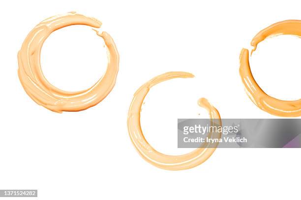 round smears of thick make-up face foundation  on white background. - white colour swatches stock pictures, royalty-free photos & images