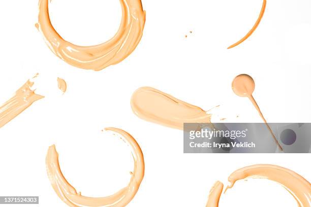 round smears of thick make-up face foundation  on white background. - concealer stock pictures, royalty-free photos & images