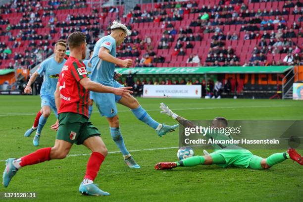 Nico Schlotterbeck of SC Freiburg scores their team's second goal past Rafal Gikiewicz of FC Augsburg during the Bundesliga match between FC Augsburg...