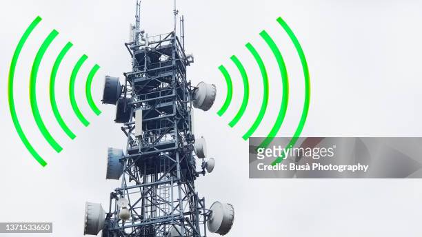 digital graphic, telecommunications signal tower (5g cell tower) with electromagnetic waves and copyspace - radio antenna stock pictures, royalty-free photos & images