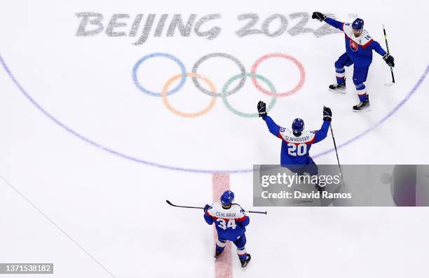 Peter Ceresnak, Juraj Slafkovsky and Peter Cehlarik of Team Slovakia celebrate a victory after the Men's Ice Hockey Bronze Medal match between Team...