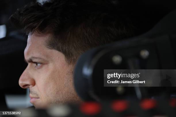 Landon Cassill, driver of the FOX Nation Chevrolet, sits in his carduring practice for NASCAR Cup Series 64th Annual Daytona 500 at Daytona...