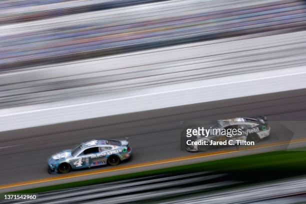 Kevin Harvick, driver of the Busch Light #BUSCHRACETEAM Ford, and Aric Almirola, driver of the Smithfield Ford, drive during practice for NASCAR Cup...