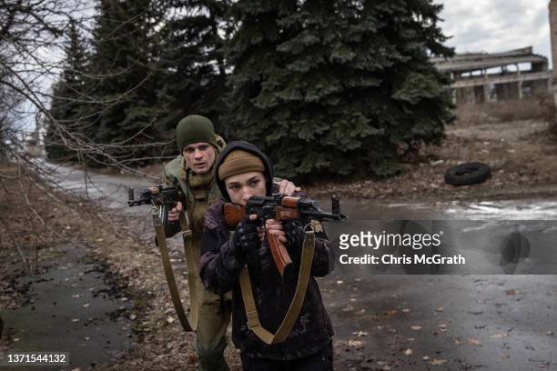An instructor guides a civilian during a military training course conducted by a Christian Territorial Defence Unit on February 19, 2022 in Kyiv,...