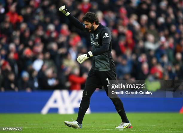 Alisson Becker celebrates after Mohamed Salah of Liverpool scored their sides second goal during the Premier League match between Liverpool and...