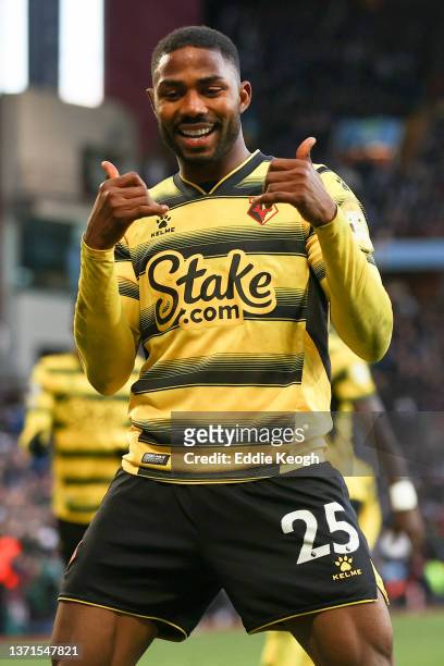 Emmanuel Dennis of Watford FC celebrates after scoring their side's first goal during the Premier League match between Aston Villa and Watford at...