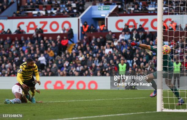 Emmanuel Dennis of Watford FC scores their side's first goal during the Premier League match between Aston Villa and Watford at Villa Park on...