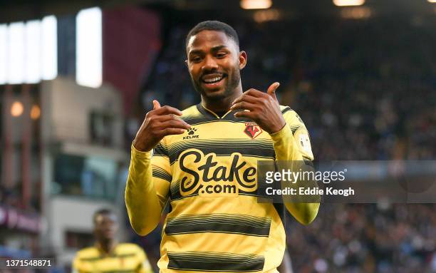 Emmanuel Dennis of Watford FC celebrates after scoring their side's first goal during the Premier League match between Aston Villa and Watford at...