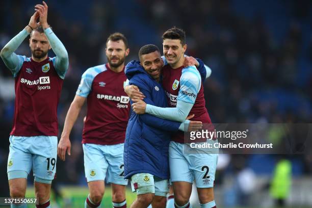 Aaron Lennon of Burnley embraces Matthew Lowton following their sides victory in the Premier League match between Brighton & Hove Albion and Burnley...