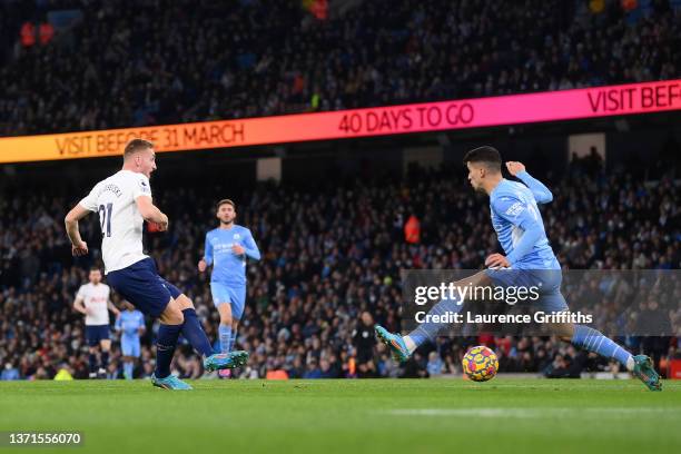 Dejan Kulusevski of Tottenham Hotspur scores their team's first goal past Joao Cancelo of Manchester City during the Premier League match between...