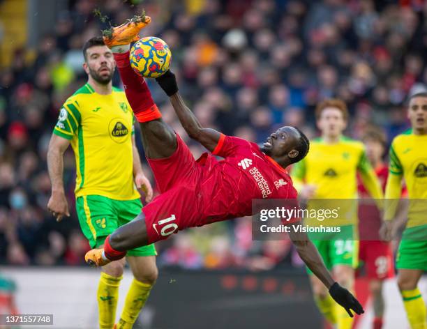 Sadio Mane of Liverpool scores their team's first goal as Grant Hanley, Max Aarons and Joshua Sargent of Norwich City look on during the Premier...