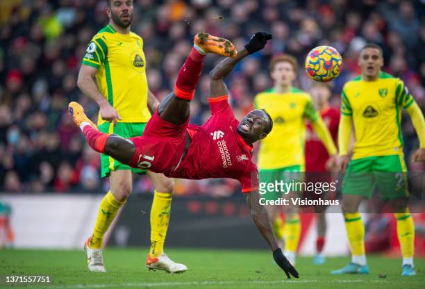 Sadio Mane of Liverpool scores their team's first goal as Grant Hanley, Max Aarons and Joshua Sargent of Norwich City look on during the Premier...