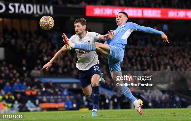 Ben Davies of Tottenham Hotspur battles for possession with Phil Foden of Manchester City during the Premier League match between Manchester City and...