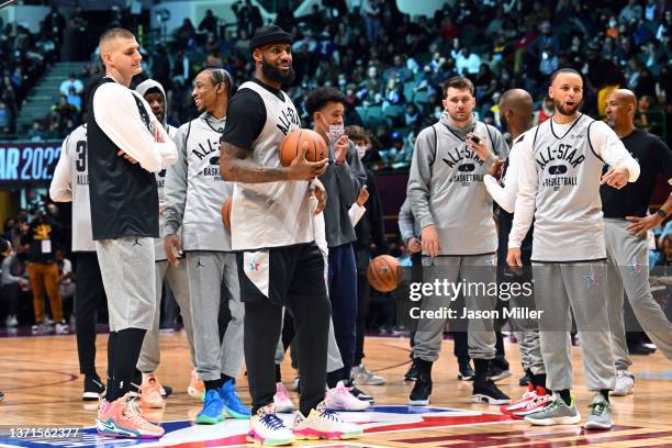 LeBron James and Stephen Curry of Team LeBron talk with teammates during the NBA All-Star practice at the Wolstein Center on February 19, 2022 in...