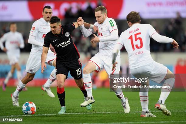 Rafael Santos Borre of Eintracht Frankfurt is challenged by Benno Schmitz of 1.FC Koeln during the Bundesliga match between 1. FC Köln and Eintracht...